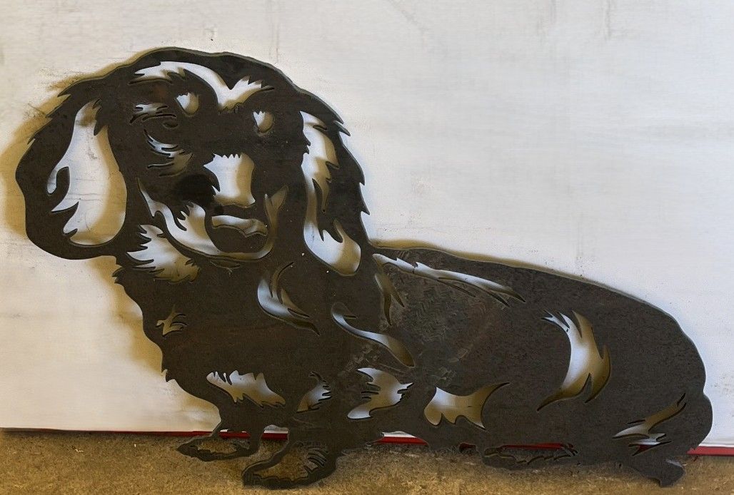 Plasma-cut long-haired dachshund silhouette in black