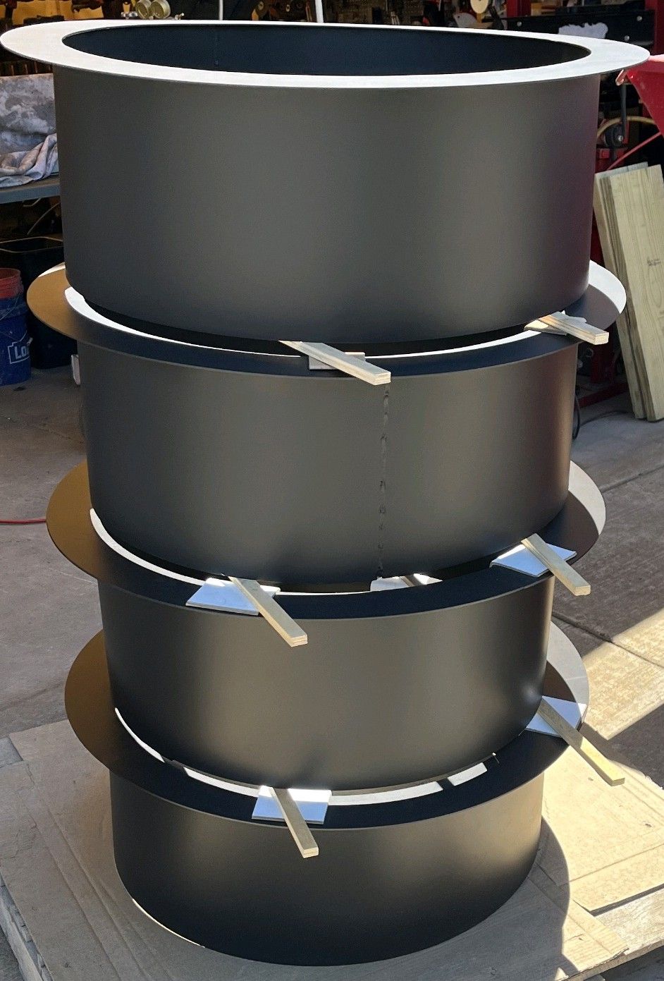 A stack of rolled fire rings in satin black after coating