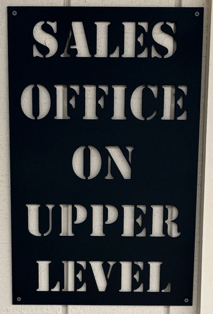 Plasma-cut steel sign reading Sales Office On Upper Level