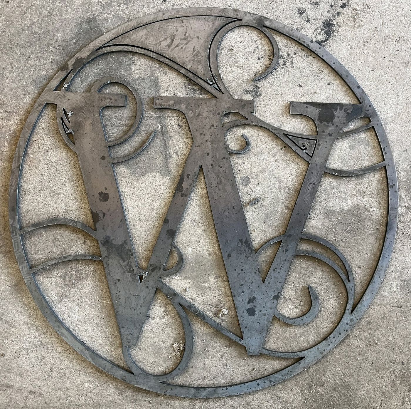 Ornate W monogram ring shown raw off the cutting table