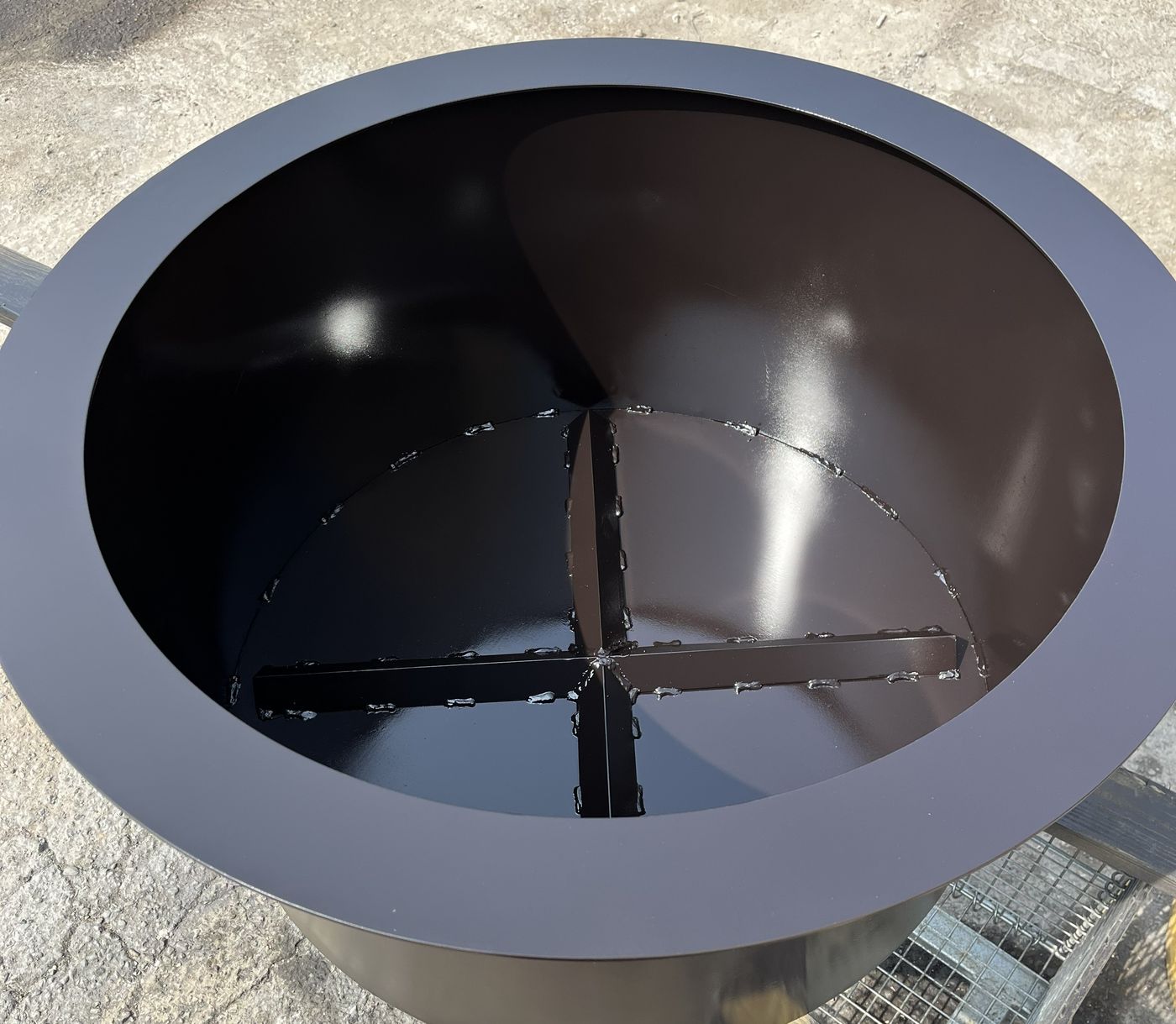 Steel fire pit bowl with welded internal cross-brace